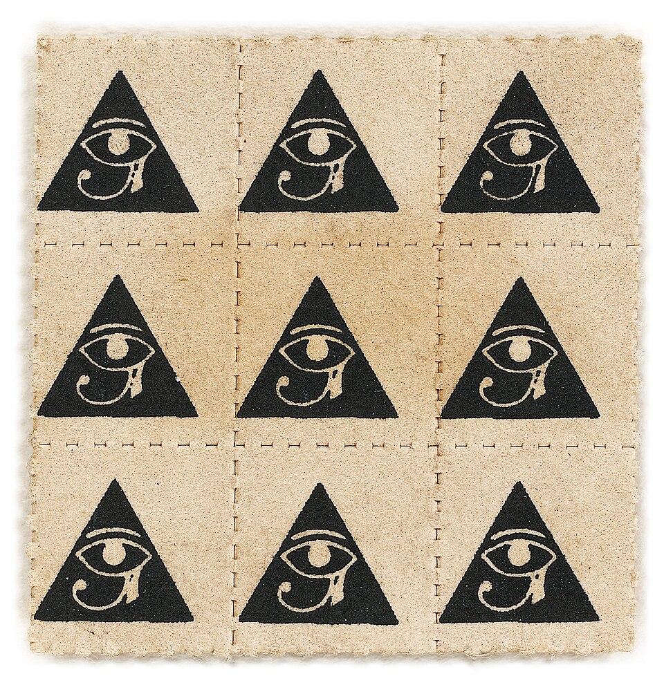 A square sheet of light brown, perforated blotter paper divided into a nine-by-nine grid of nine individual squares. Each square features an identical black stamp of a triangle containing the ancient Egyptian Eye of Horus symbol. The edges of the paper are rough and fibrous.