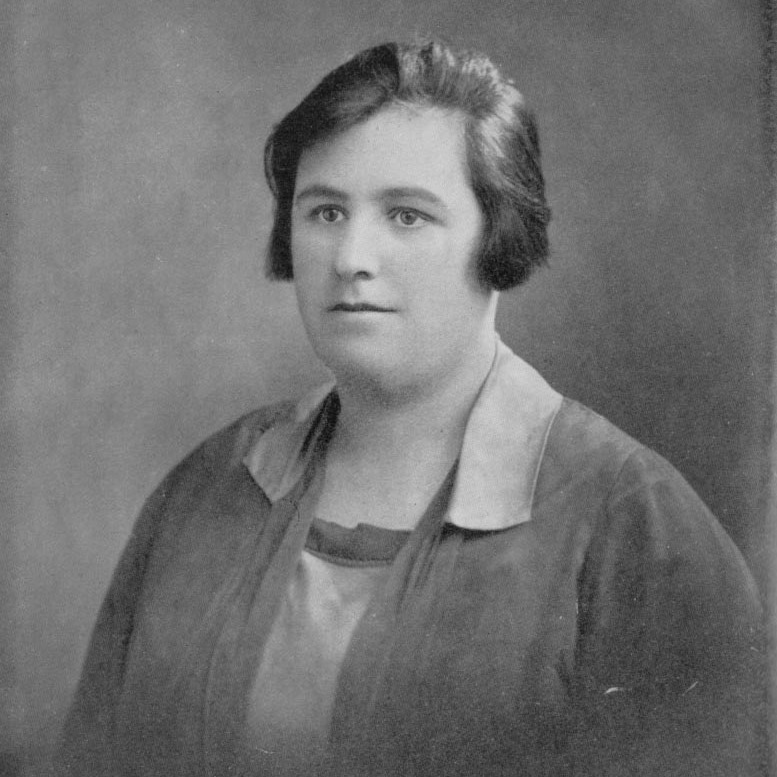 A black and white studio portrait photograph of a young Helen Duncan from the chest up, set against a neutral, softly textured background. She has short, dark hair styled in a bob and is looking slightly away from the camera. She wears a dark jacket or cardigan over a light-colored blouse with a prominent collar.