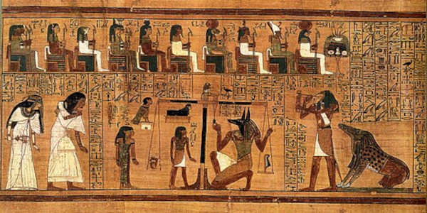 A vibrant ancient Egyptian painted papyrus scroll scene depicting the Weighing of the Heart. On the left, the jackal-headed god Anubis kneels beneath a massive scale, adjusting its center balance. On the left scale pan sits a small white vessel containing the deceased's heart; on the right pan rests the white feather of Ma'at. To the right, the ibis-headed scribe god Thoth stands holding a reed pen and a palette to record the final spiritual judgment.
