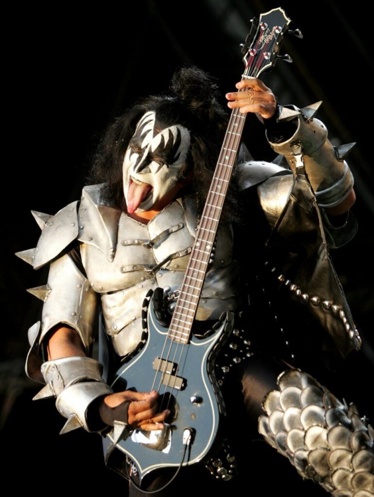 Gene Simmons of the rock band KISS performing live on stage in full makeup and costume