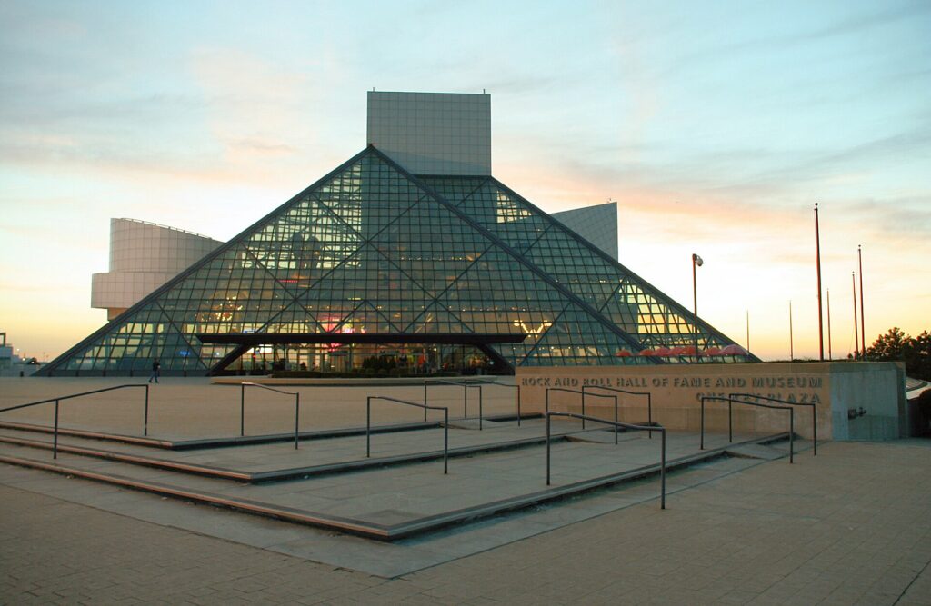 Wide exterior photograph of the glass pyramid architecture of the Rock and Roll Hall of Fame museum in Cleveland Ohio