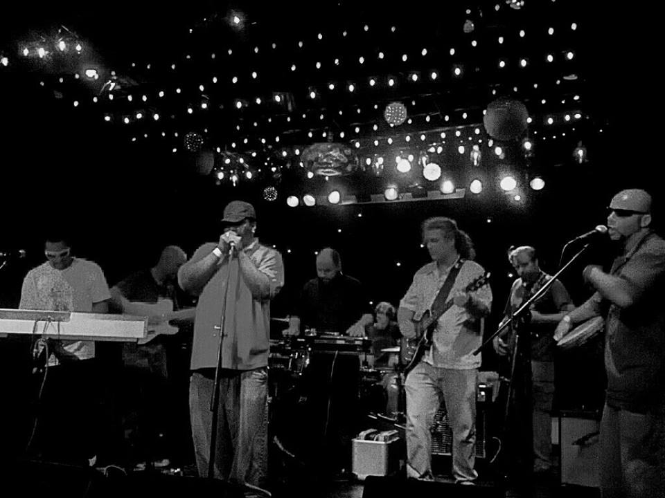 Black and white live performance photograph of bi-racial hip hop band, The Deep End, performing on stage at the Bottletree Cafe in Birmingham Alabama circa 2010.